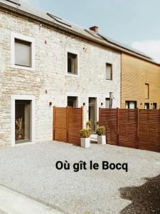 西内Où gît le Bocq Spa privatif的砖砌的建筑,有栅栏,我们送给布尔科的礼物