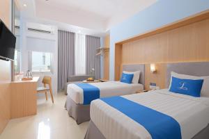 Hotel Laksana Solo Managed By Dafam客房内的一张或多张床位