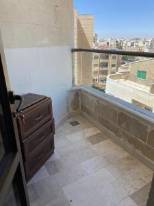 安曼شقة مفروشة للايجار في عمان شارع الجامعة الاردنية的阳台配有梳妆台和窗户。