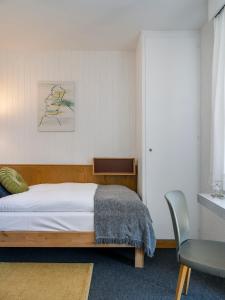 克莱恩 蒙塔纳Chez Elsy - Crans-Sapins的一间卧室配有一张床和一把椅子
