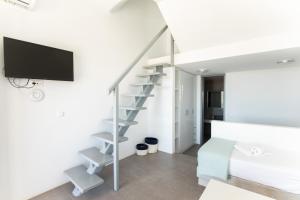 帕瑞加Lectus Mykonos的一间白色的公寓,房间内设有螺旋楼梯