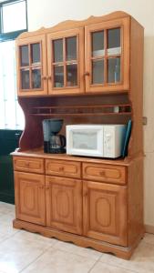 波文图拉Boaventura Home Comfort的上面有微波炉的木柜