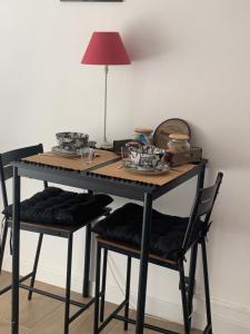 马赛Studio L Oustaou的一张桌子,上面有两把椅子和一盏灯