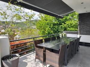 布达厄尔什Private Family Villa的阳台的用餐室配有桌椅