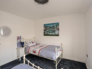 阿姆奇13 Quay Street的卧室配有一张床,墙上挂着一幅画