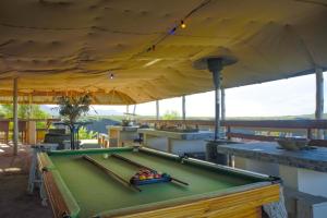克拉格斯Rainforest Ridge Eco Resort的甲板上的一张台球桌,配有天篷