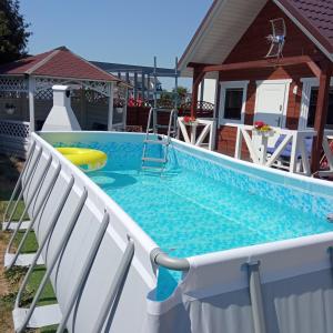 弗瓦迪斯瓦沃沃Domki letniskowe Na Stoku的一个带两把椅子的游泳池和一个游泳池