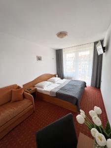 梅尔诺薇拉米兰民宿的一间卧室配有一张床和一张沙发