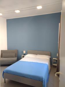 米拉佐LA REGGIA APARTMENTS MILAZZO的一间卧室配有一张大床和一张沙发
