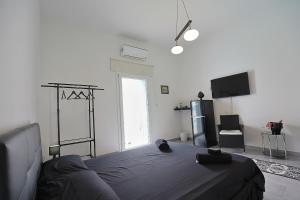 拉卡莱Salentuosi Camere的一间卧室配有一张床和一台电视。
