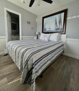 Cedar PointWaterway Inn的卧室配有一张大床,墙上挂有绘画作品