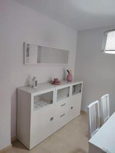 马贝拉Sunny Guadalmina Apartment的客房内的白色橱柜和镜子