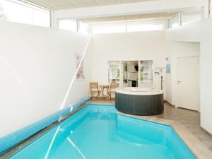 Udsholt Sand8 person holiday home in Gr sted的一座房子内的一个室内游泳池,内配浴缸