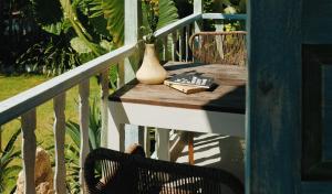 蓝梦岛Sandy Bay的阳台上的桌子,带花瓶和书