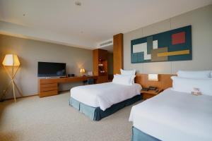 尾道市尾道贝拉维斯塔温泉码头酒店的酒店客房设有两张床和一台平面电视。