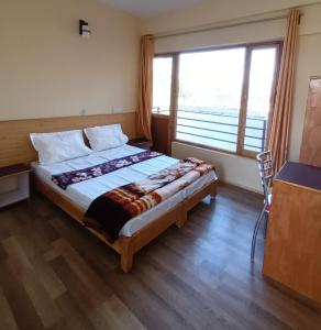 列城Gonbo Guest House的一间卧室设有一张大床和大窗户