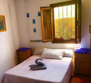 格拉纳达CUEVA EL DUENDE的一间卧室设有两张床和窗户。