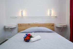 萨洛Codolar Planetcostadorada的一间卧室配有带毛巾和鲜花的床