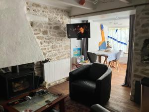 和尚岛Petite maison de pêcheur的客厅配有椅子和壁炉