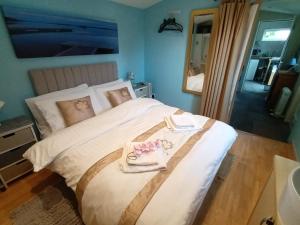 威特尼Private Suite in Oxfordshire, A40的一间卧室配有一张大床和毛巾