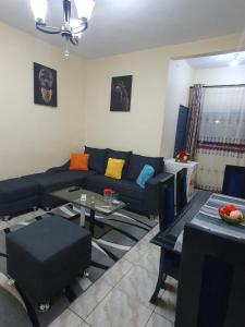 杜阿拉Appartement Cosy & Chill的客厅配有蓝色的沙发和桌子