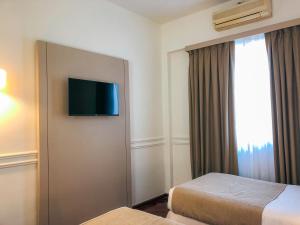 布宜诺斯艾利斯El Misti Hotel Buenos Aires Centro的酒店客房设有两张床和一台平面电视。