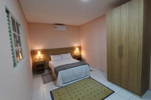 圣保罗Vida Real Hostel的一间卧室设有一张床和一个滑动玻璃门