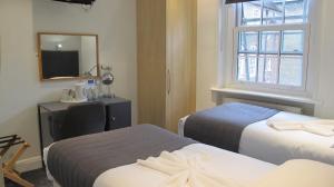 伦敦阿尔罕布拉酒店的酒店客房,设有两张床和镜子
