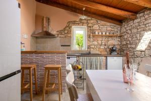 罗波里卡House Boris的厨房设有石墙和桌子