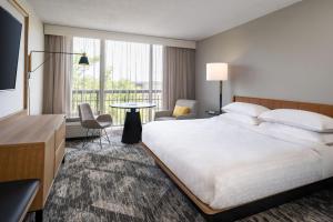奥兰多奥兰多北喜来登酒店的酒店客房设有一张大床和一张桌子。