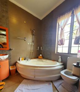 内罗毕Edaala Comfort - B&B的带浴缸和卫生间的大型浴室