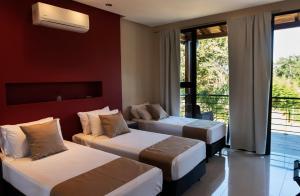 伊瓜苏港Tekoa Lodge的酒店客房设有两张床和一个阳台。