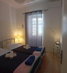 伊兹拉Smaragdas Paradise的一间卧室设有两张床和窗户。