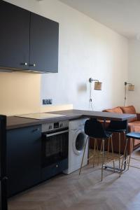 蒙彼利埃Appartement 2 pièces Montpellier centre的厨房配有洗衣机和桌椅