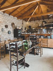希马拉ELÉA Guesthouse himare的一间带木桌和椅子的用餐室