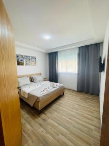 古莱比耶Luxus-Apartment mit Poolblick的一间卧室配有一张床,铺有木地板