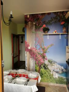 勒亚尼法鲁Green Apple Guesthouse的一张桌子,上面有盘子和眼镜,还有一幅城市画