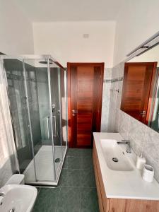 迪亚诺马里纳Luxury Guest House - Diano Marina的一间带玻璃淋浴和水槽的浴室