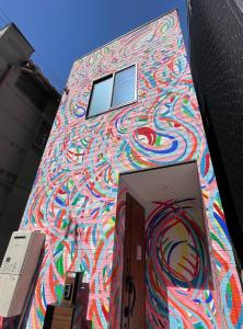 大阪ART HOUSE-アートハウス友家tomoya-的一面有画的建筑物