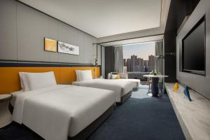 合肥合肥滨湖voco酒店的酒店客房设有两张床和一台平面电视。