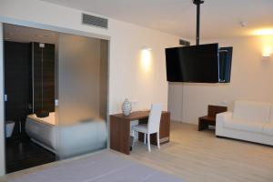 法萨诺桑特利亚公园酒店的带沙发、桌子和电视的客厅