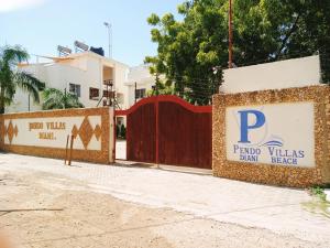 迪亚尼海滩Pendo Villas Diani Beach的带有读取付费别墅的标志的栅栏,用来喝海滩