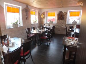 海德克塞博德斯穆旅馆的餐厅设有木桌、椅子和窗户。