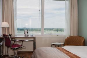 阿兰达Clarion Hotel Arlanda Airport Terminal的配有一张床、一张书桌和一扇窗户的酒店客房