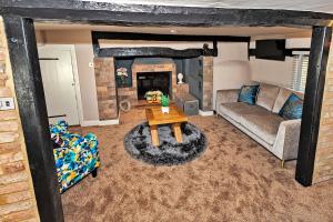 Finest Retreats - Pemberley Cottage的客厅配有沙发和桌子