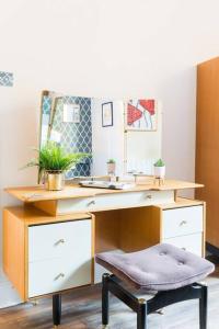 利明顿温泉Garden Apartment in Listed Building的浴室设有一张带镜子和凳子的书桌