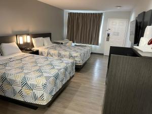 丘拉维斯塔圣地亚哥南湾戴斯酒店的酒店客房设有两张床和窗户。
