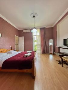 西格纳吉典雅公寓的一间卧室配有一张带红色毯子的大床