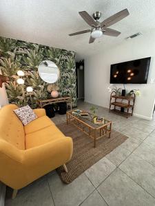 迈阿密Miami's Cozy Tropical Getaway的客厅设有黄色沙发和电视