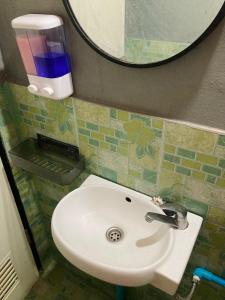 梭桃邑โรงแรมคุ้มเดช - KoomDech Hotel的浴室设有白色水槽和镜子